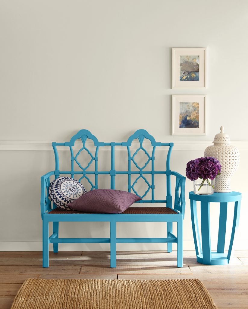 Bench and side table in deep cool blue against soft neutral walls.
