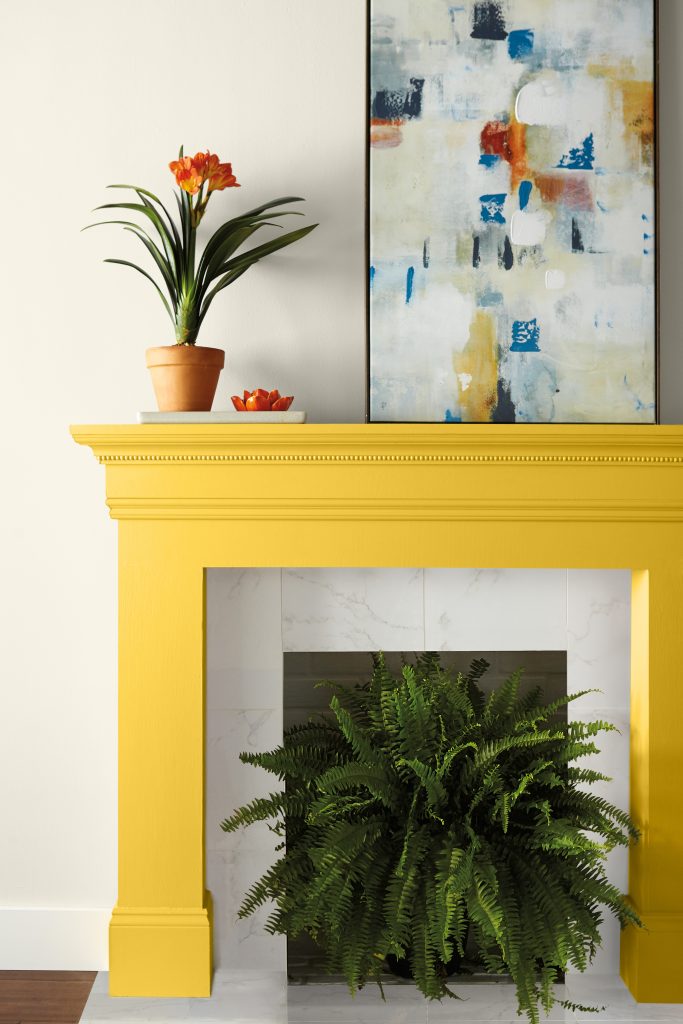 Cozy fireplace painted in a warm golden yellow.