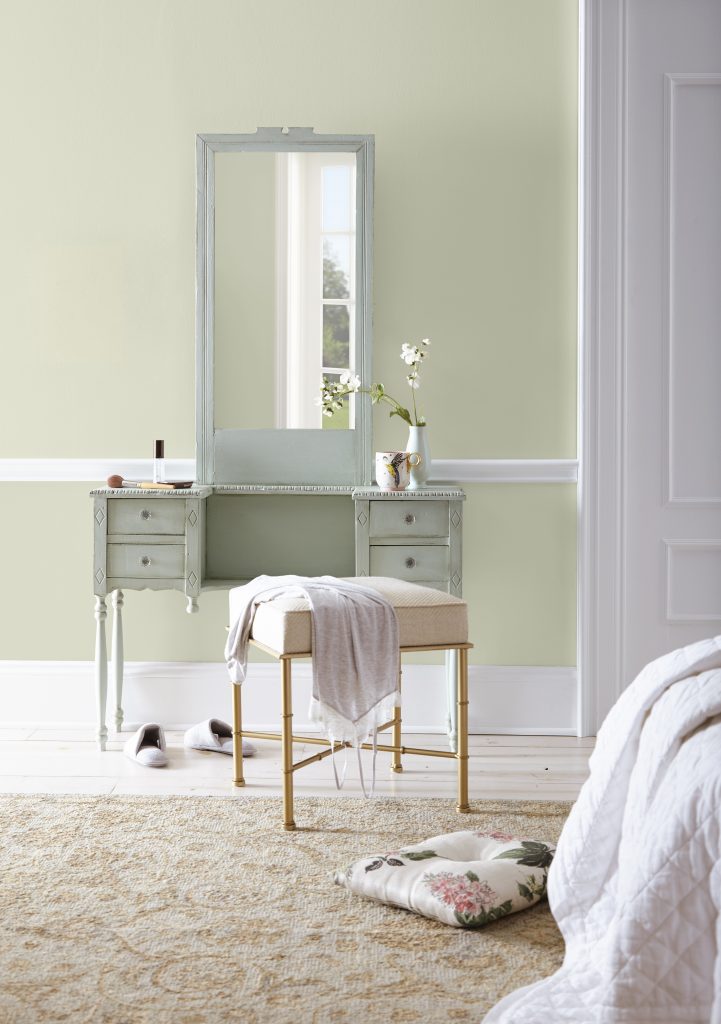 Bathroom vanity painted in soft pastel green Positive Energy S370-1 with warm white walls and light neutral decor.