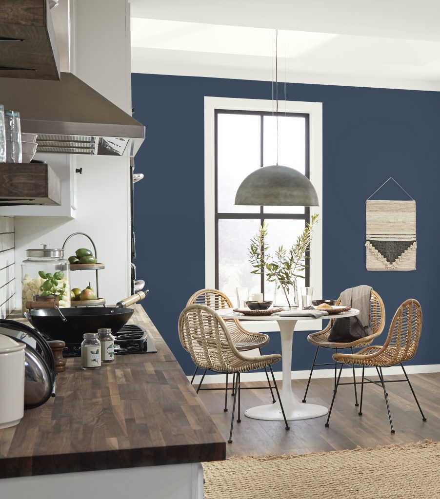 Kitchen with deep cabinets, painted in Very Navy, white walls, and warm wood accents.