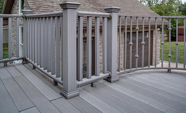 Grey composite outdoor deck with railing and planks