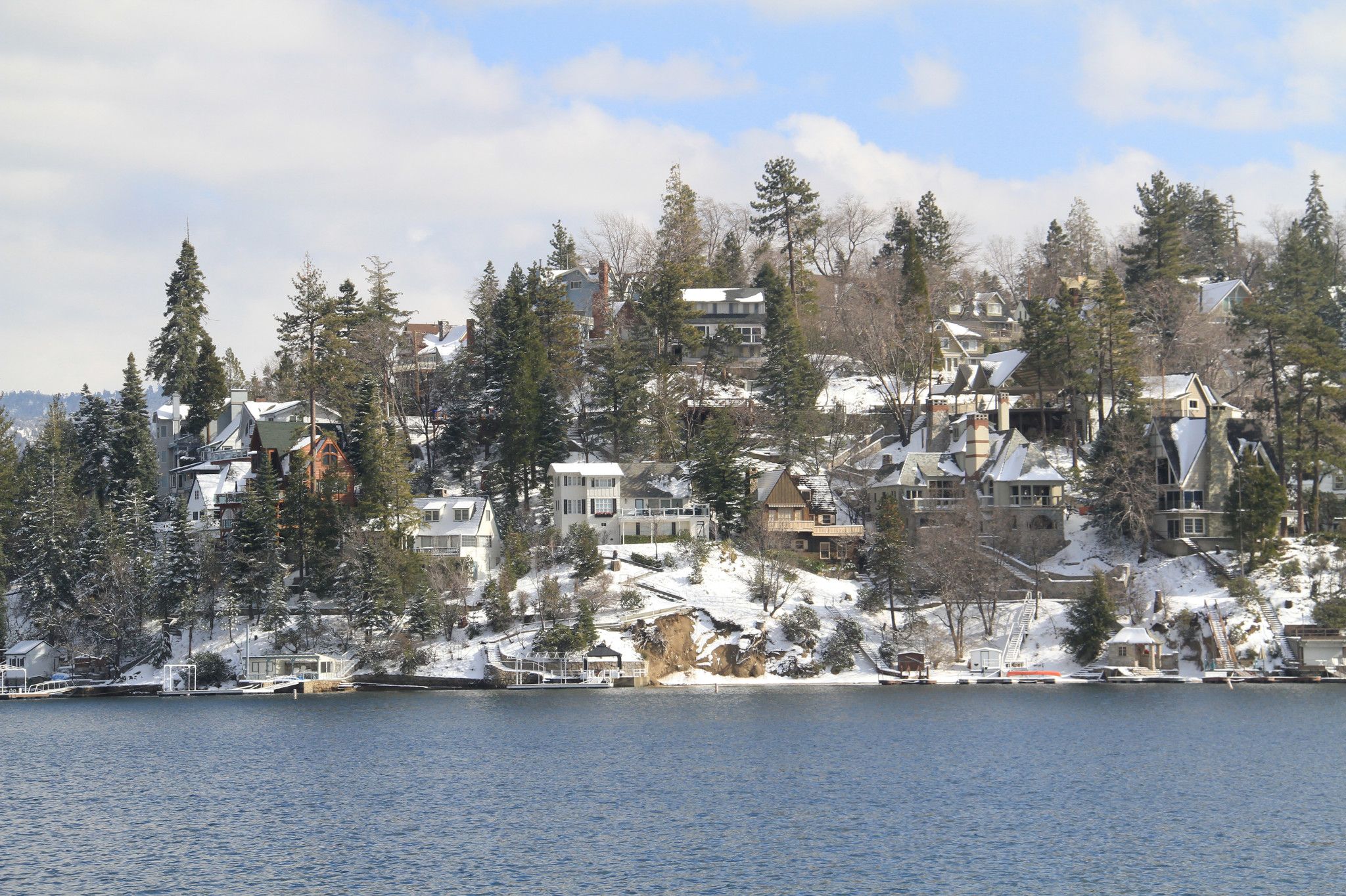 Houses perched on a lake during winter